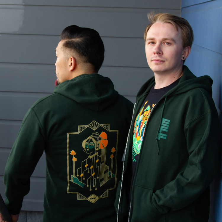 Person wearing a green hoodie with a gold motherboard figure and orange poppies on the back, next to a person wearing an EFF35 Cityscape member t-shirt.