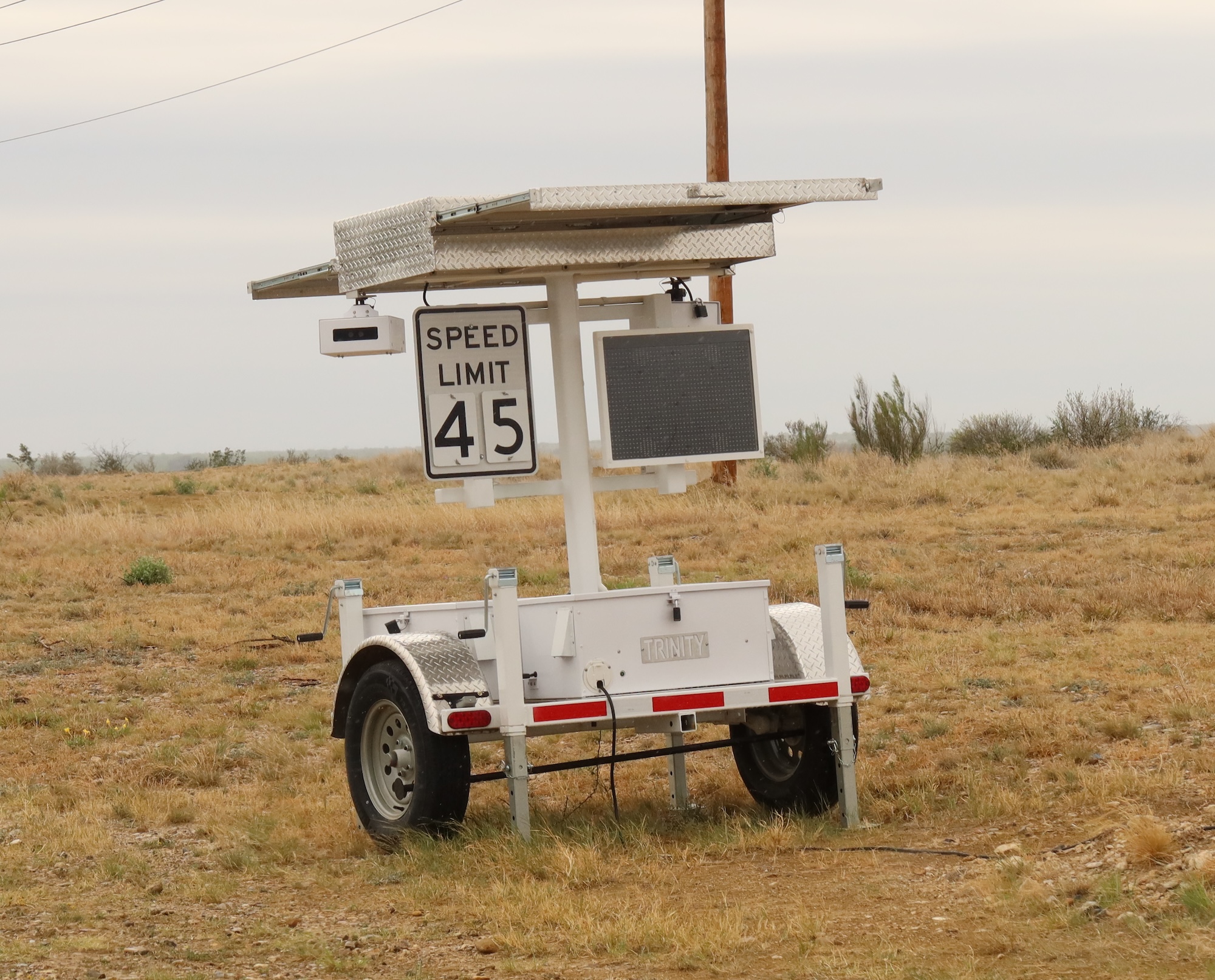 A speed trailer capturing ALPR. Speed limit 45 sign. 